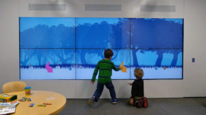 Young patients play with the wall in the waiting room